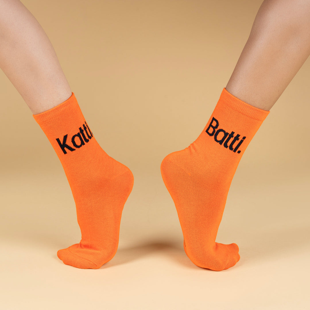 Orange socks with black text on a beige background