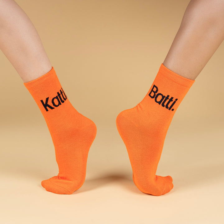 Orange socks with black text on a beige background