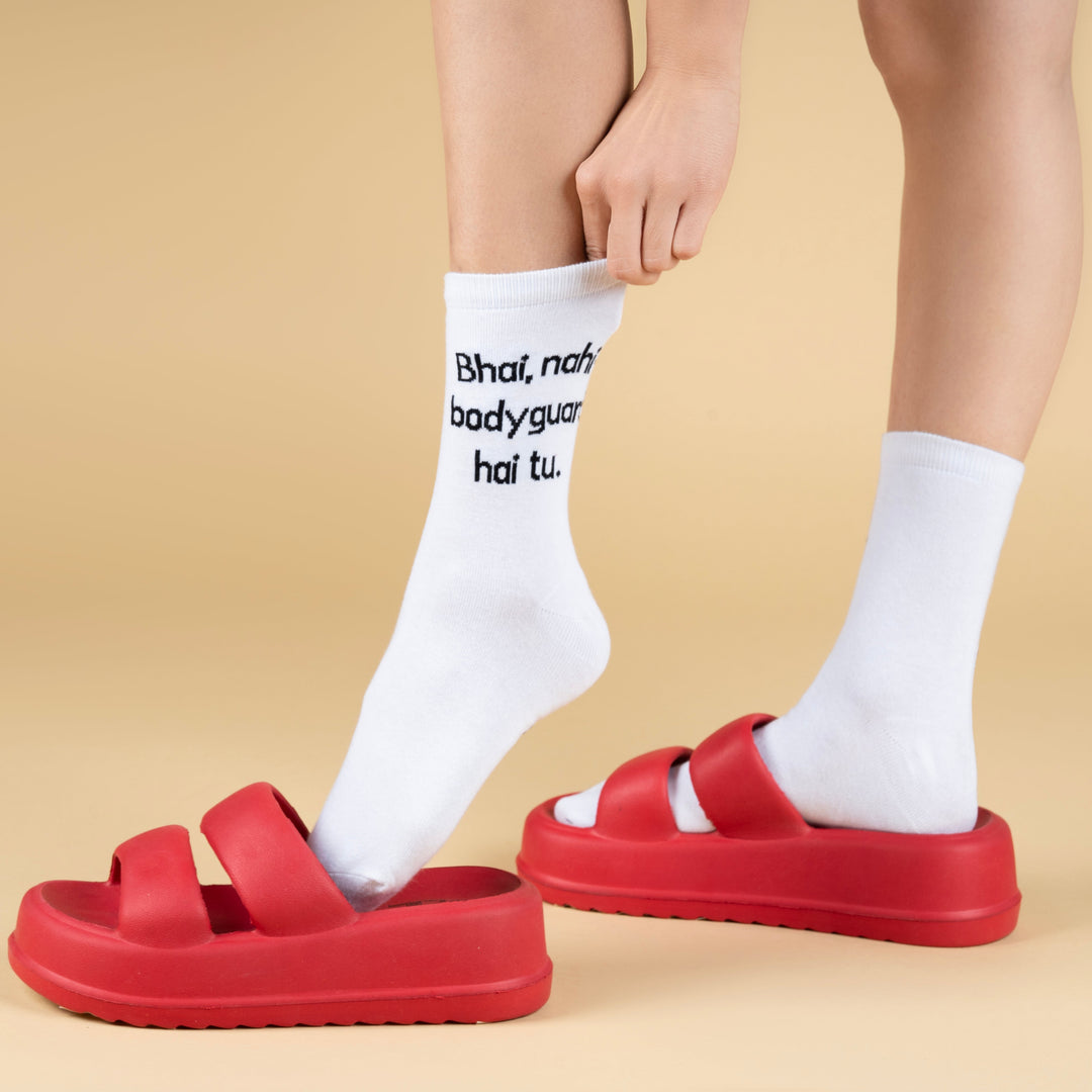 Red sandals worn with white socks on a beige background