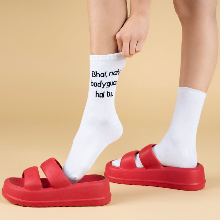 Red sandals worn with white socks on a beige background