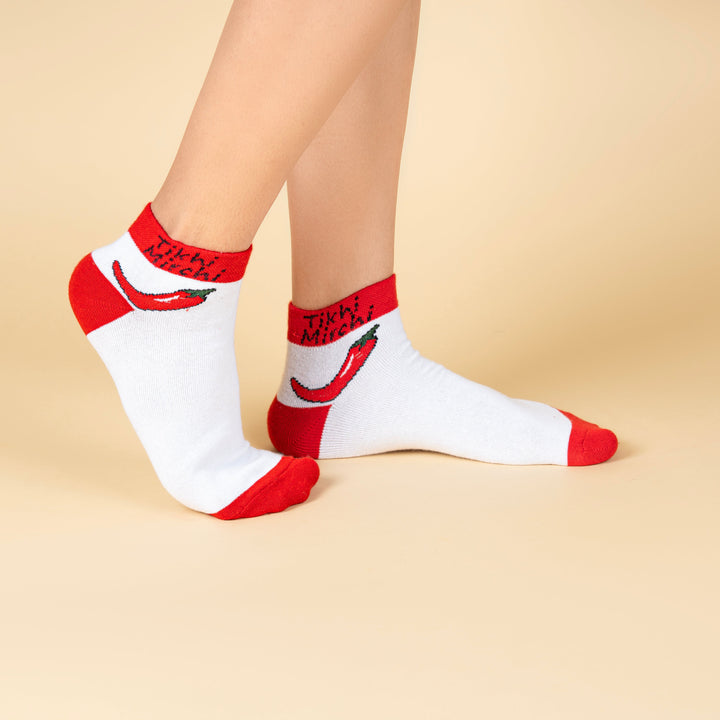 White socks with red accents worn by a person on a beige background