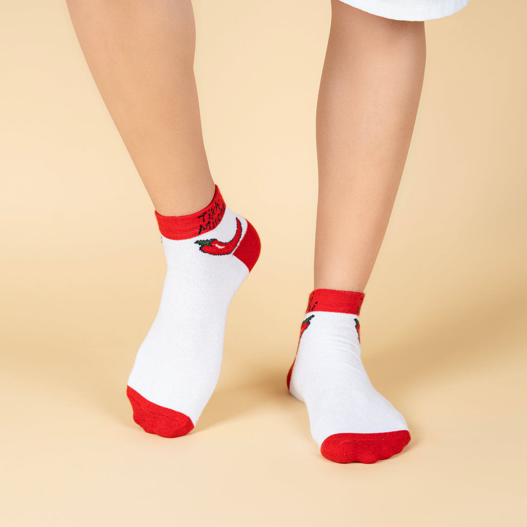 White socks with red accents worn by a person on a beige background-Tikhi Mirchi- Fun Expression-