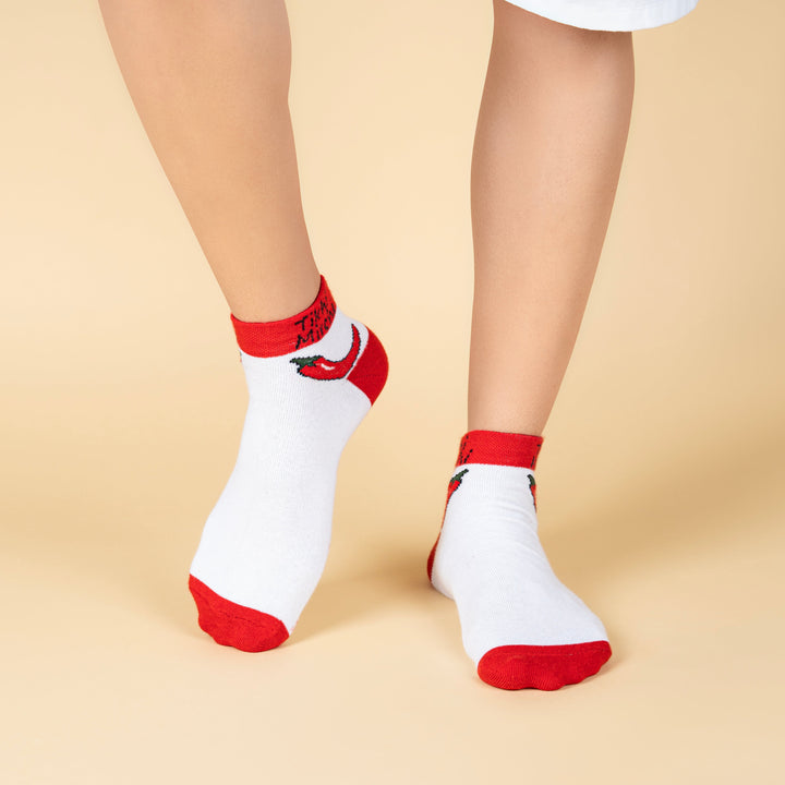 White socks with red accents worn by a person on a beige background