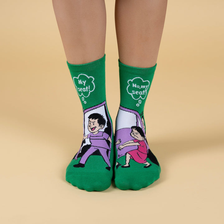 Green socks with cartoon characters on a beige background