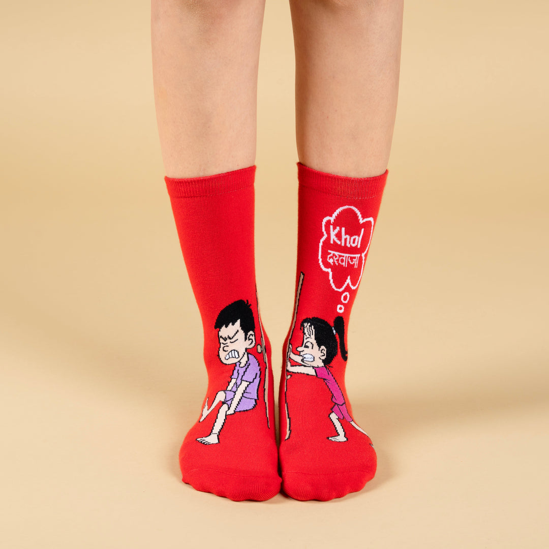Red socks with cartoon characters and text on a beige background