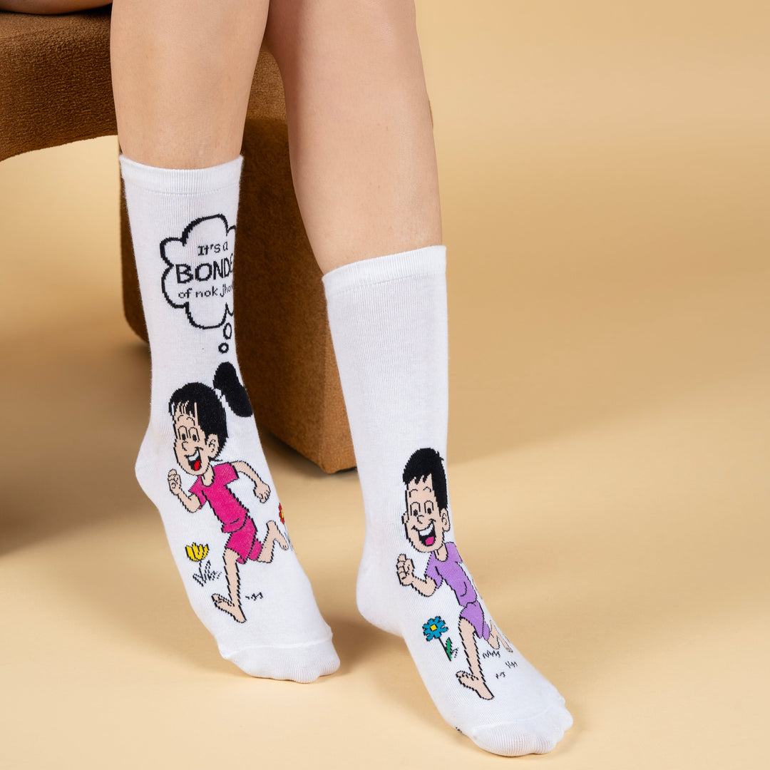 White socks with cartoon characters and text worn by a person on a beige background