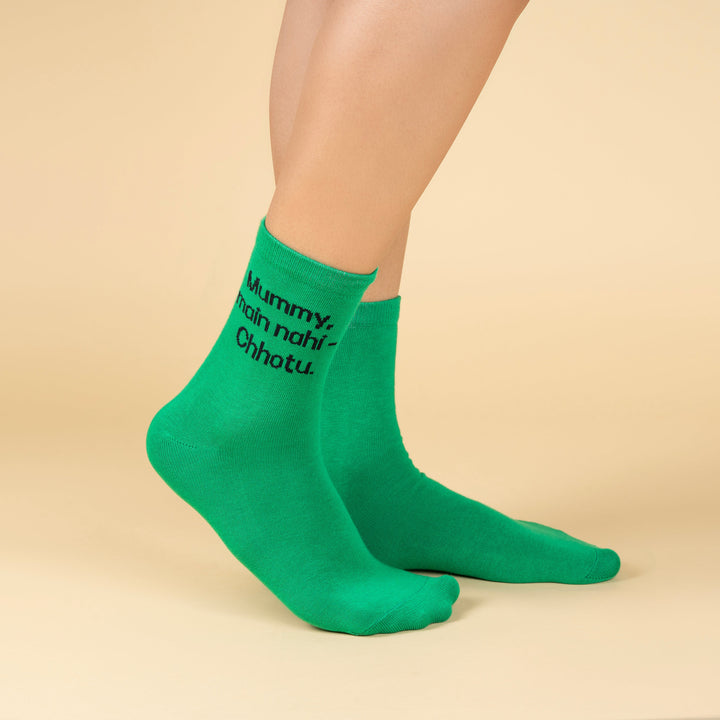 Green socks with text worn by a person on a beige background-MUMMY ME NAHI CHOTU- DIALOGUE SOCKS-