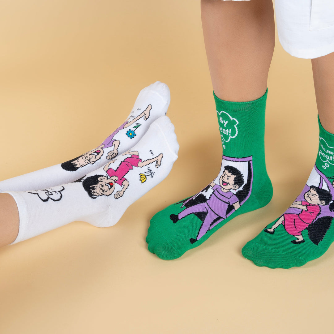 White and green socks with cartoon characters on a beige background