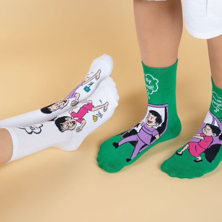 White and green socks with cartoon characters on a beige background