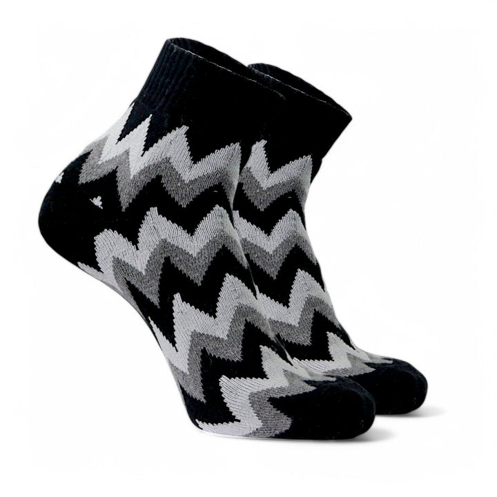 Close-up of black zigzag cotton ankle socks showing soft fabric texture